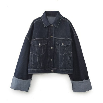 Dark denim jacket front with chest pockets, buttons, and gray cuffed sleeves