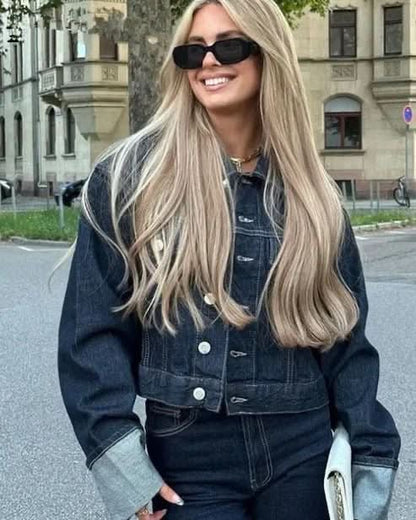 Cropped dark denim jacket with button front and rolled light blue cuffs