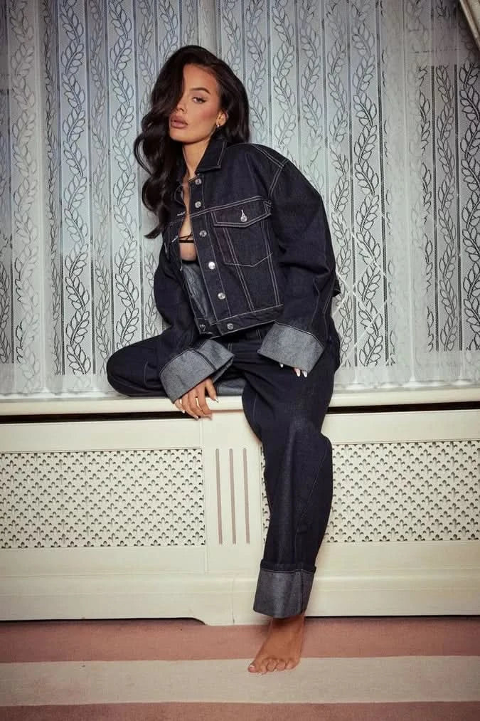 Dark denim two-piece set with cropped jacket and high-waisted jeans with cuffed hems