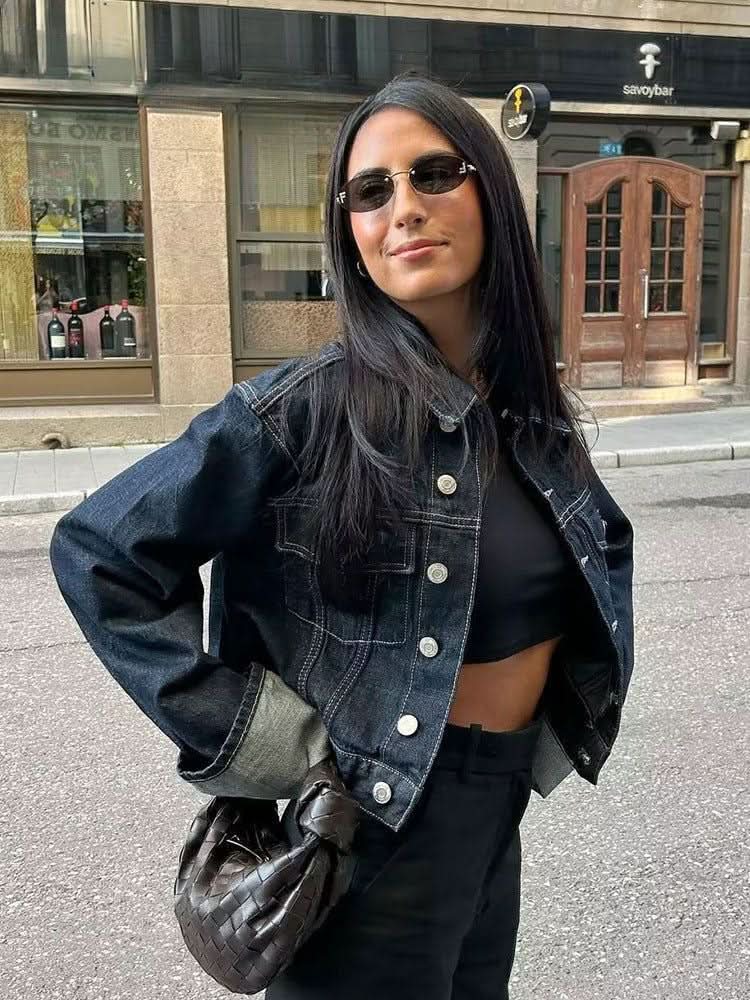 Oversized dark denim jacket with light blue rolled sleeves worn with dark jeans