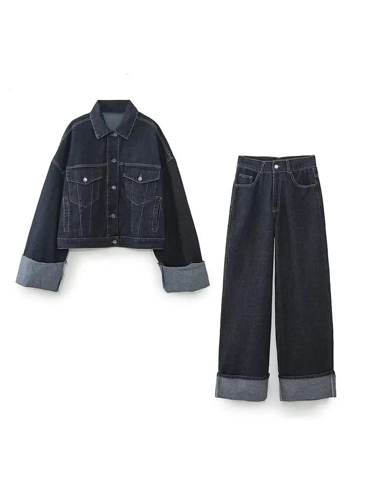 Dark denim jacket with light blue rolled cuffs and wide-leg dark jeans with rolled hems