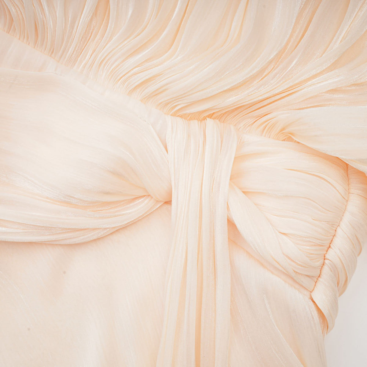 Cream pleated fabric texture showing fine vertical pleats throughout