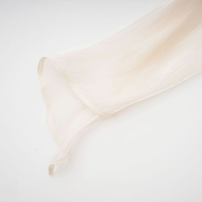 Cream pleated fabric sleeve showing delicate vertical pleating