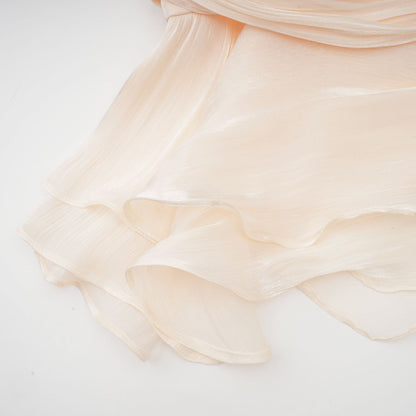 Ruffled hem of cream mini dress with layered scalloped edges