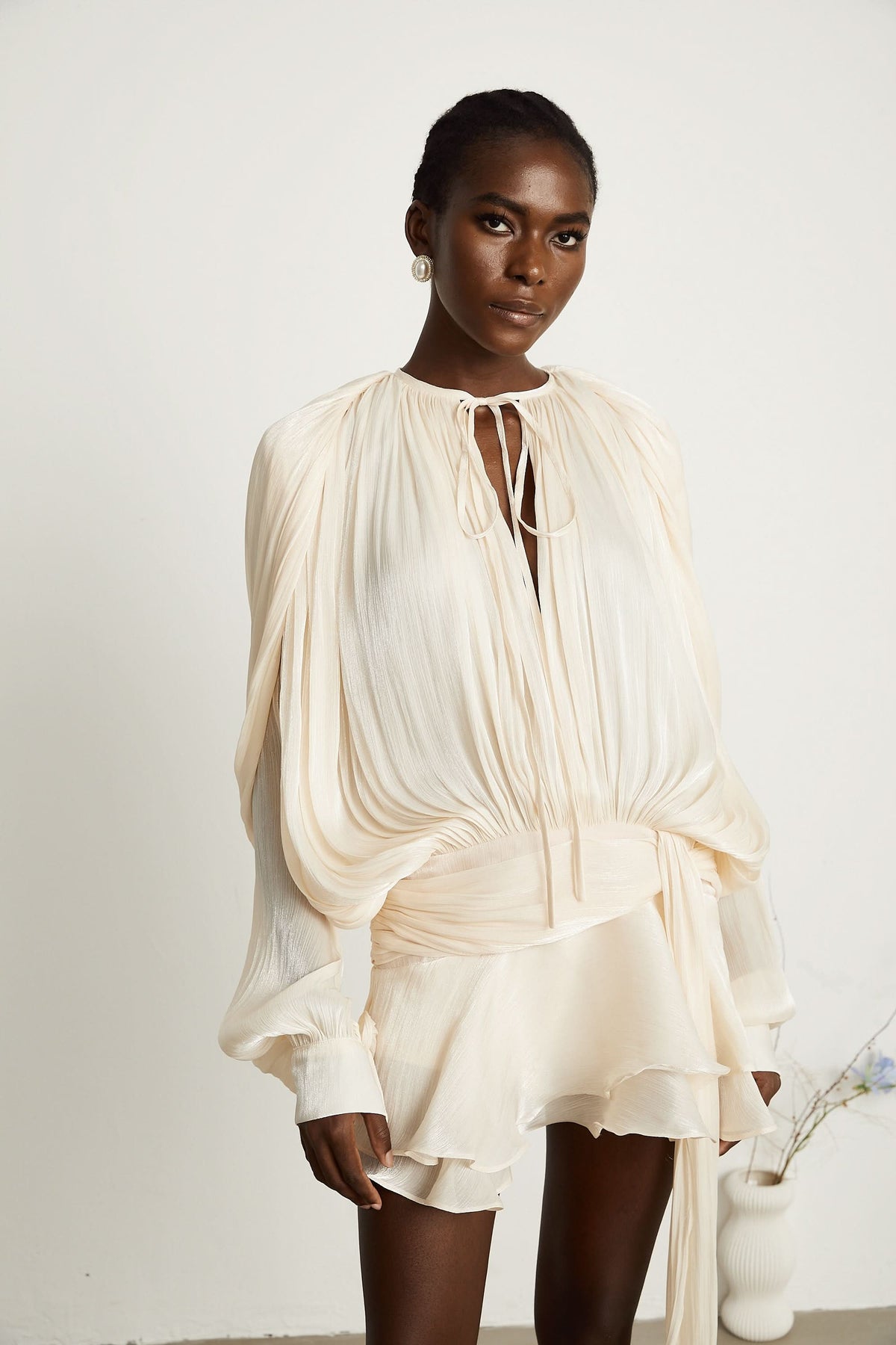 Cream ruffled mini dress with voluminous sleeves and tiered ruffle skirt