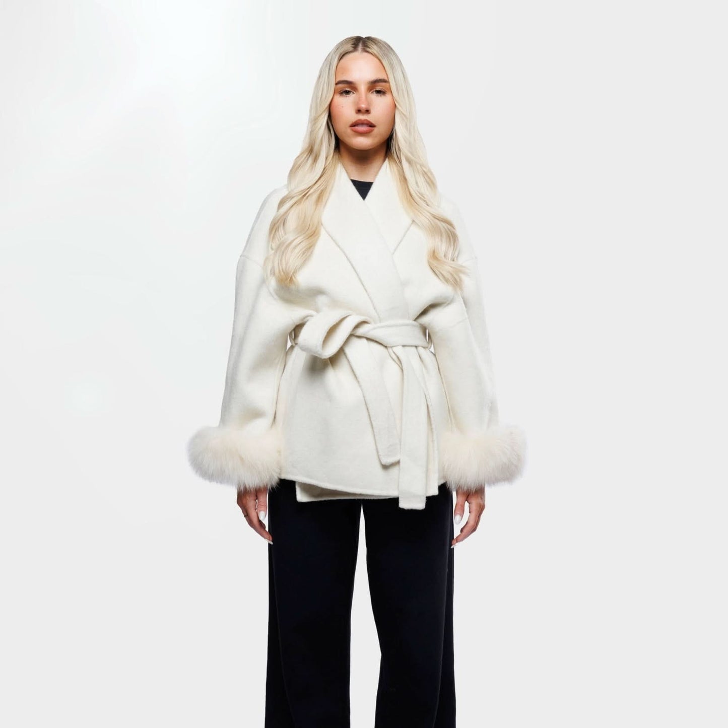 Ivory luxury coat with fur-trimmed cuffs and tie waist, front view