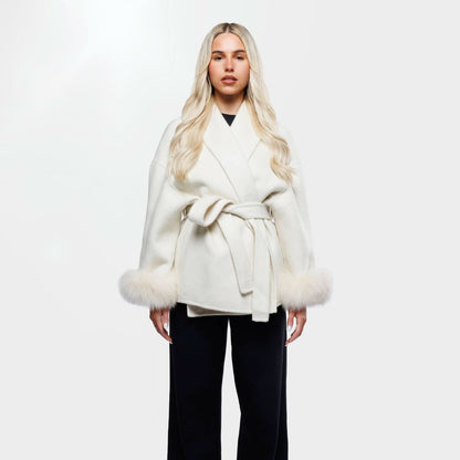 Ivory luxury coat with fur-trimmed cuffs and tie waist, front view