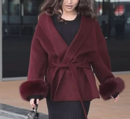 Burgundy wrap coat with faux fur cuffs and collar over black ribbed top