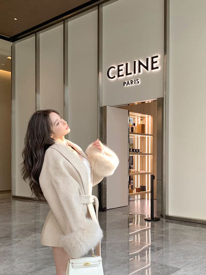 Cream luxury coat with fur-trimmed sleeves and tie waist, side view