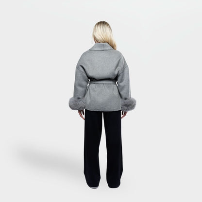 Gray wool coat with fur sleeve trim and cinched waist, back view