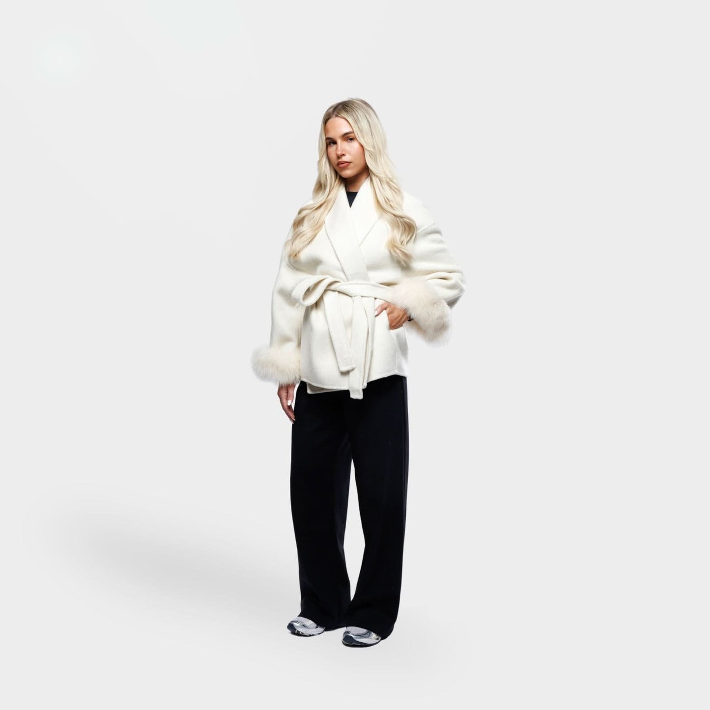 Ivory wrap coat with fur-trimmed sleeves and belt detail, side angle