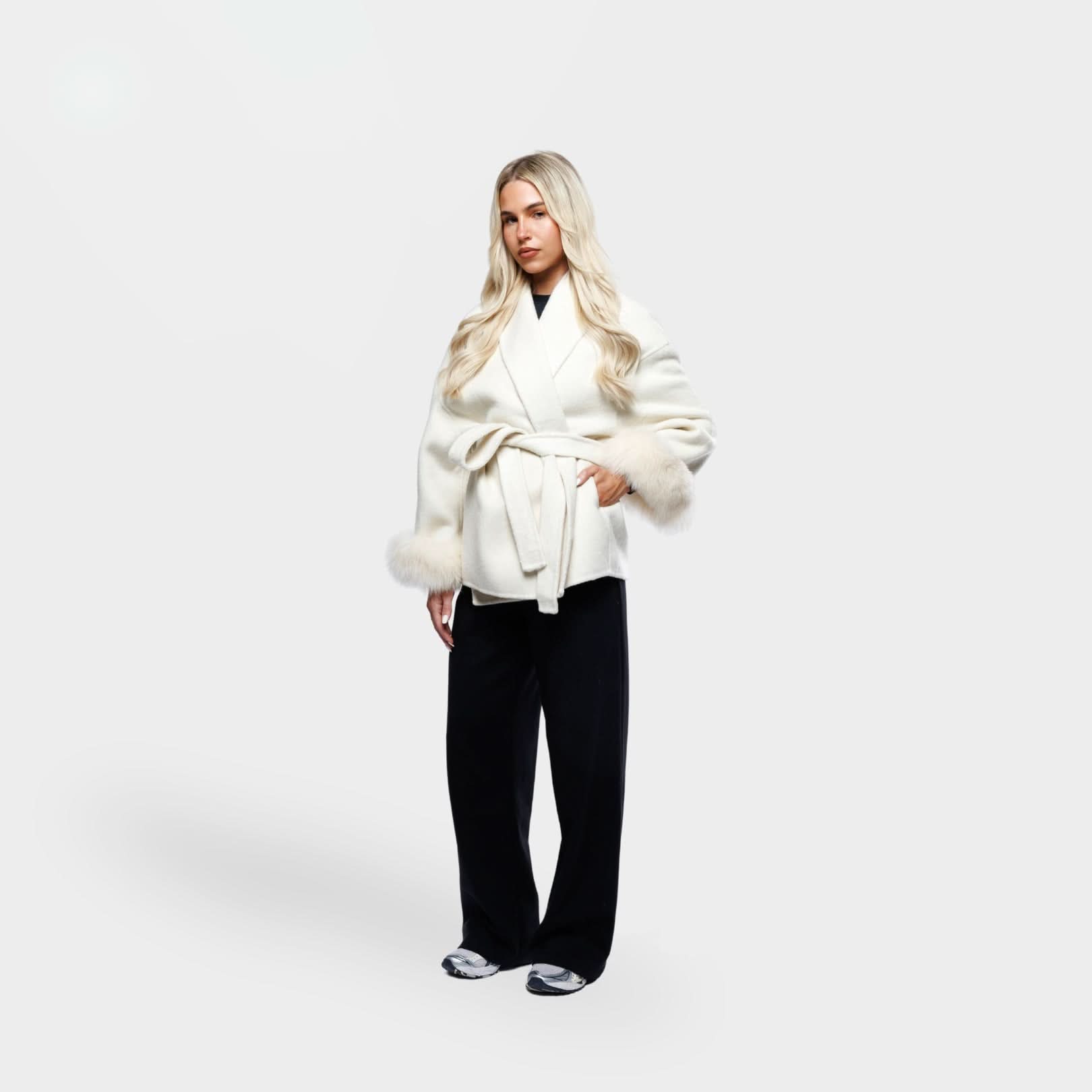 Ivory wrap coat with fur-trimmed sleeves and belt detail, side angle