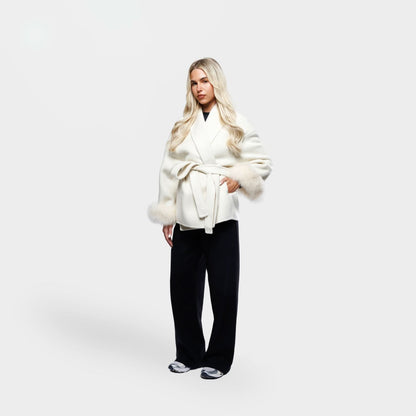 Ivory wrap coat with fur-trimmed sleeves and belt detail, side angle