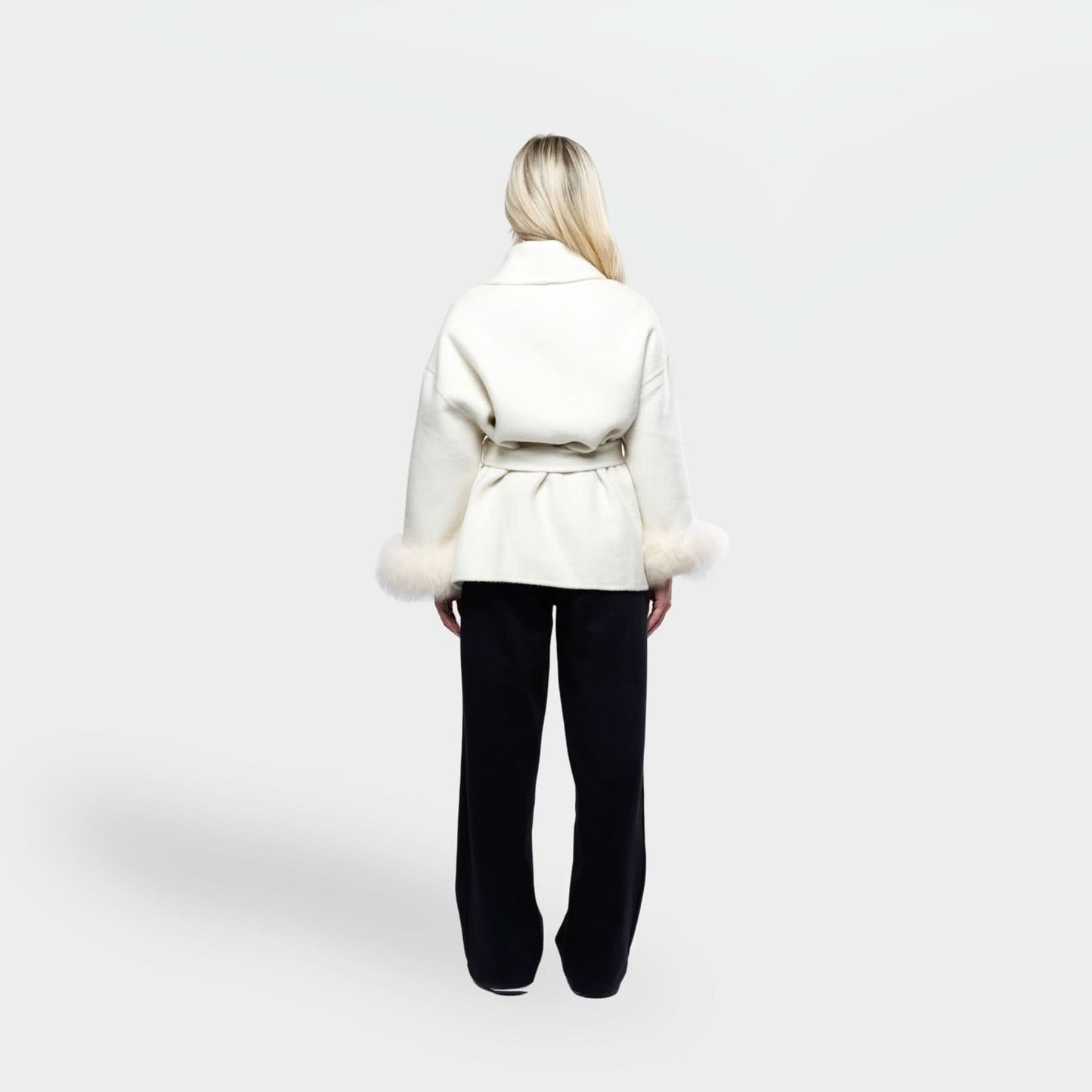 Cream coat with fur cuff trim and tie waist, back view