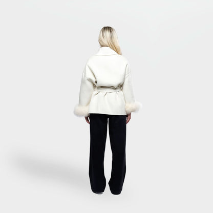 Cream coat with fur cuff trim and tie waist, back view