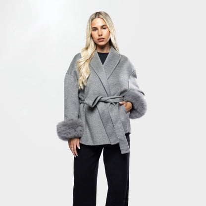 Gray wool coat with fur cuffs and wrapped belt, front portrait view
