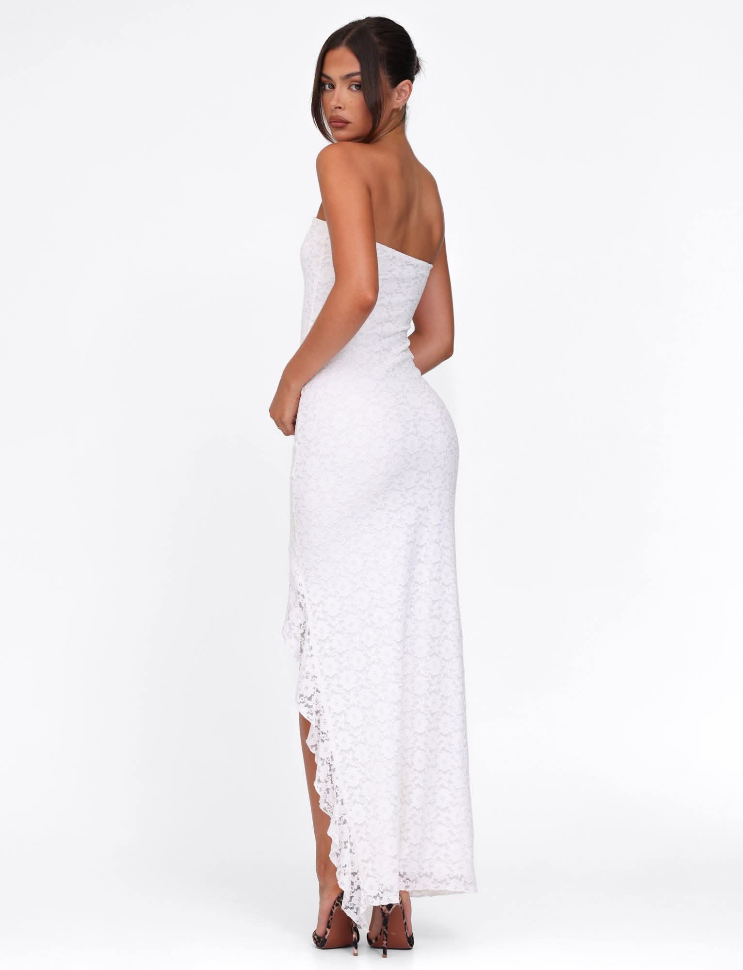 Side view of white lace strapless maxi dress with high slit detail