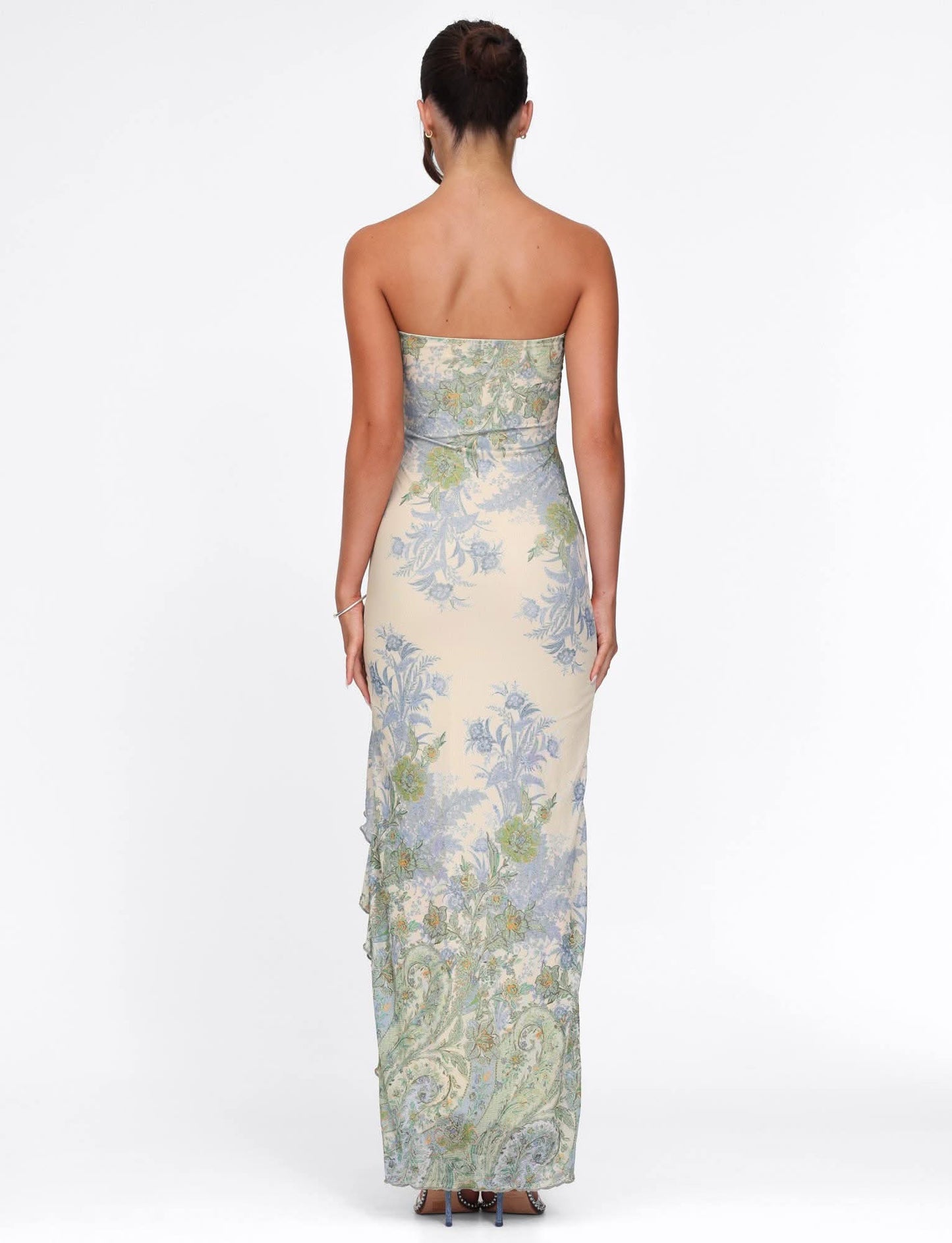 Back view of strapless cream maxi dress with blue and green floral pattern