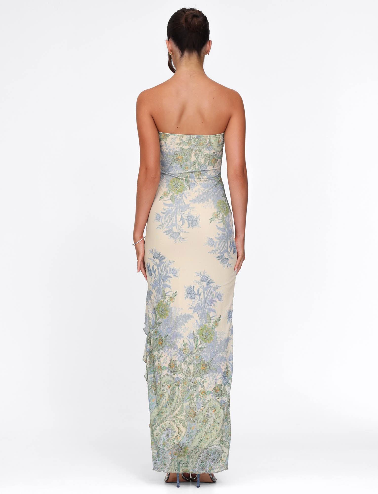 Back view of strapless cream maxi dress with blue and green floral pattern