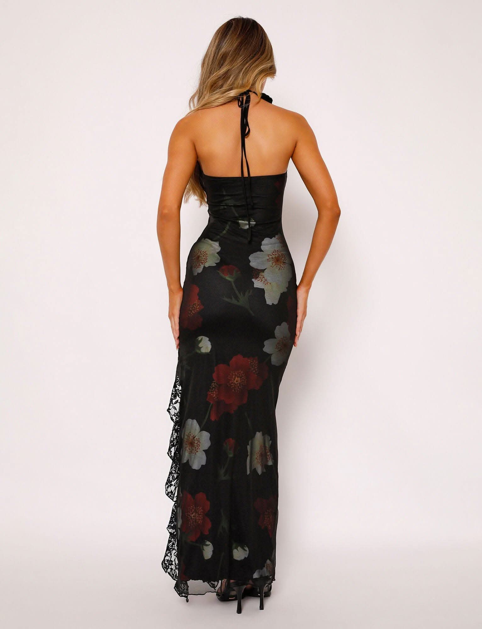 Back view of black strapless maxi dress with white and red floral design