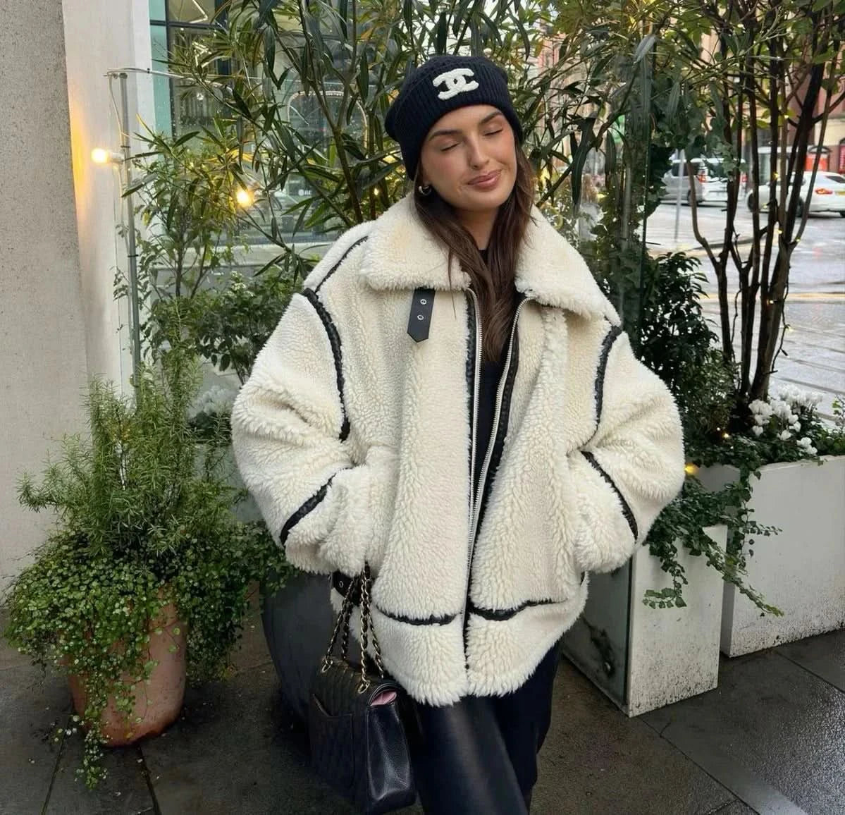 Cream teddy coat with black trim and collar, full front zip closure detail