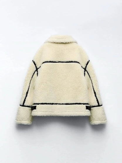 Back flat lay of cream teddy coat with black piping and seam details