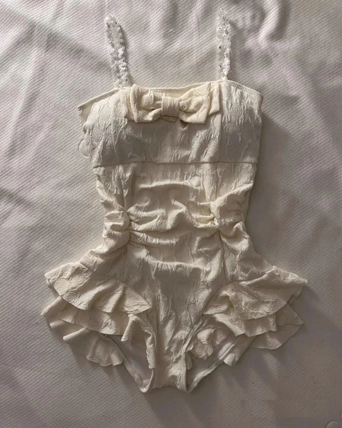 Cream textured floral one-piece swimsuit with square neckline and ruffled skirt for women
