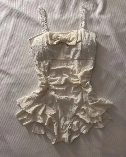 Cream textured floral one-piece swimsuit with square neckline and ruffled skirt for women