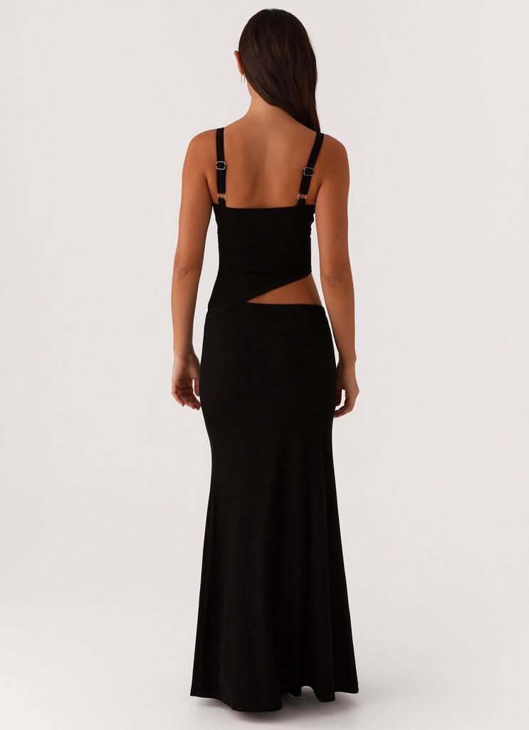Back view of black maxi dress with waist cutout and straps