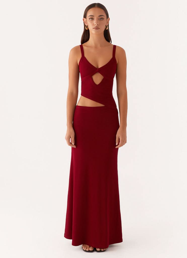 Deep red maxi dress with V-neckline, cutout chest detail, and thin straps