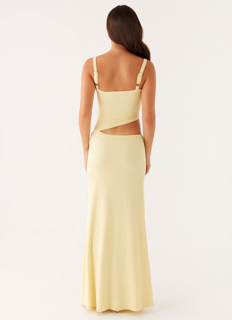 Back view of pale yellow maxi dress showing open back with cutout
