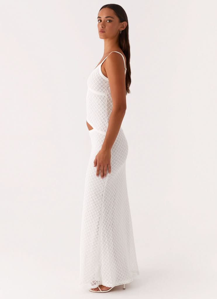 Side view of white maxi dress with diamond pattern and side cutout
