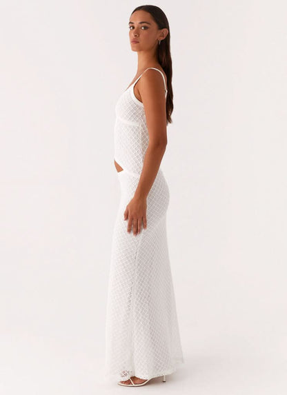 Side view of white maxi dress with diamond pattern and side cutout