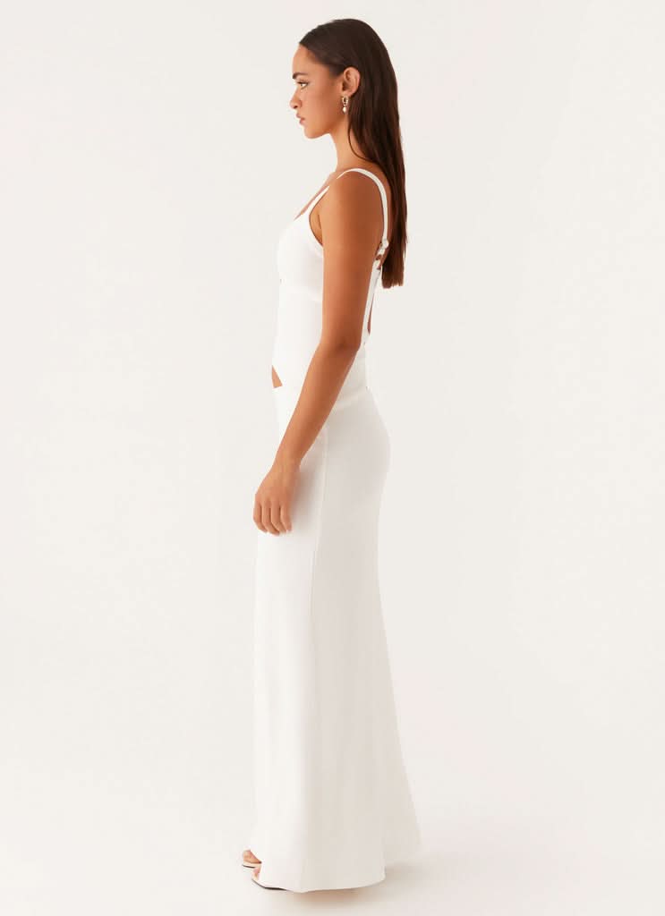 Side view of white maxi dress with side cutout detail and thin straps