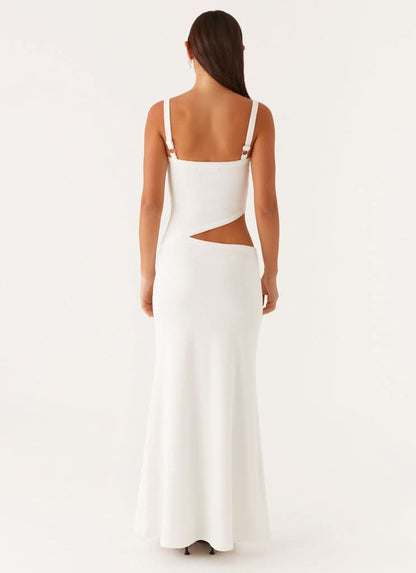 Back view of white maxi dress showing open back cutout and strappy design