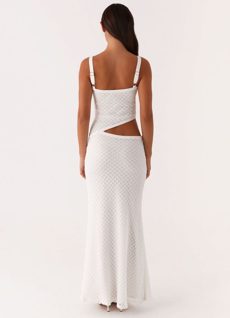 Back view of white maxi dress showing open back cutout detail