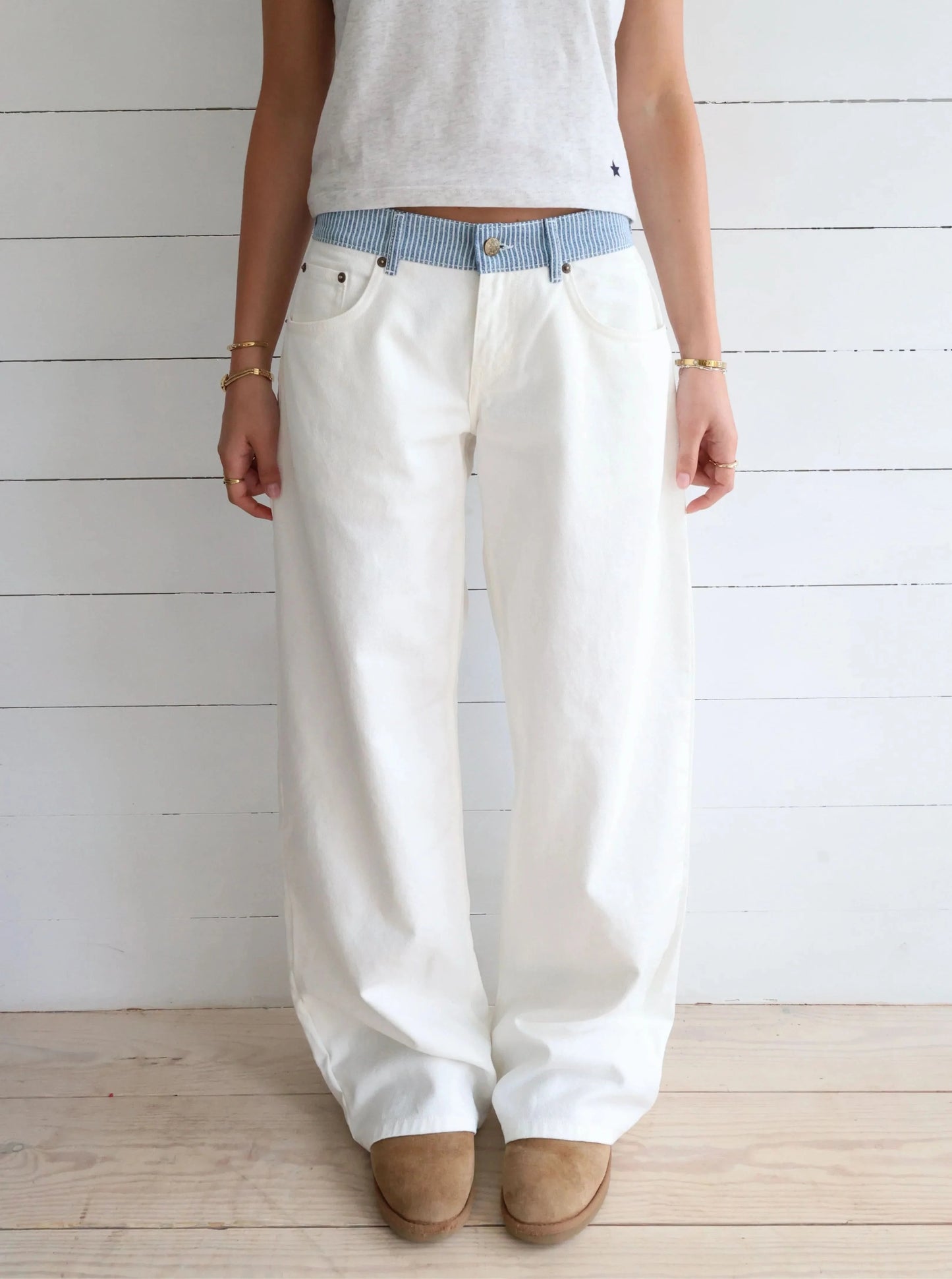 White denim jeans with blue striped waistband, front view full length
