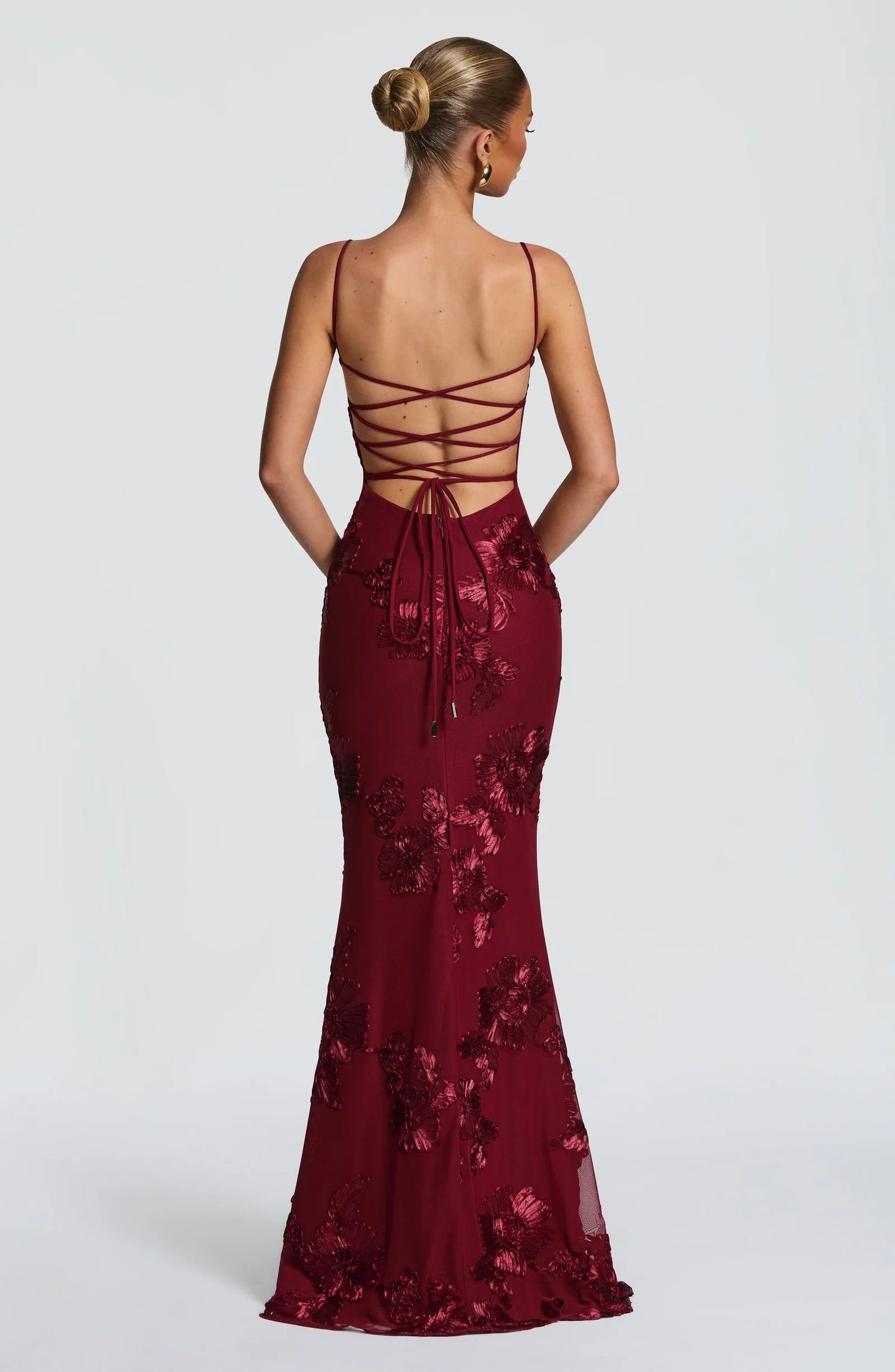 Back view of burgundy floral maxi dress with lace-up corset back detail