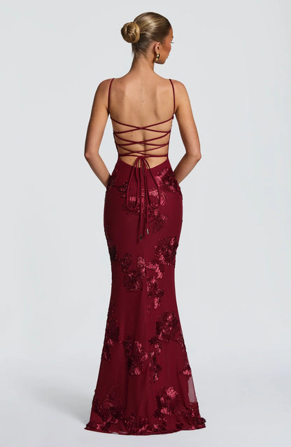 Back view of burgundy floral maxi dress with lace-up corset back detail