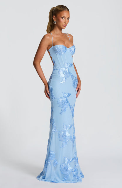 Side profile of light blue floral corset maxi dress with fitted bodice