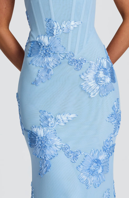 Close-up detail of light blue embroidered floral pattern on corset dress