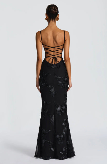 Back view of black floral corset maxi dress with lace-up corset back