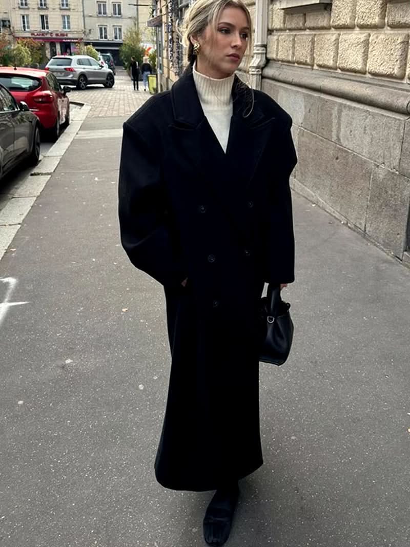 Black wool long coat with oversized collar and double-breasted buttons styled with cream turtleneck