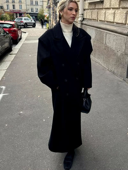 Black wool long coat with oversized collar and double-breasted buttons styled with cream turtleneck