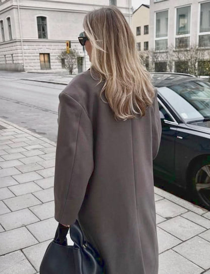 Taupe long coat back view showing relaxed fit and length