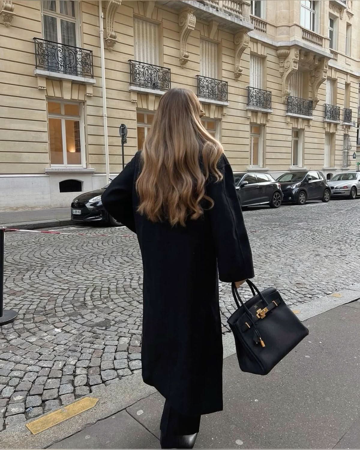 Black long coat with oversized silhouette and button front