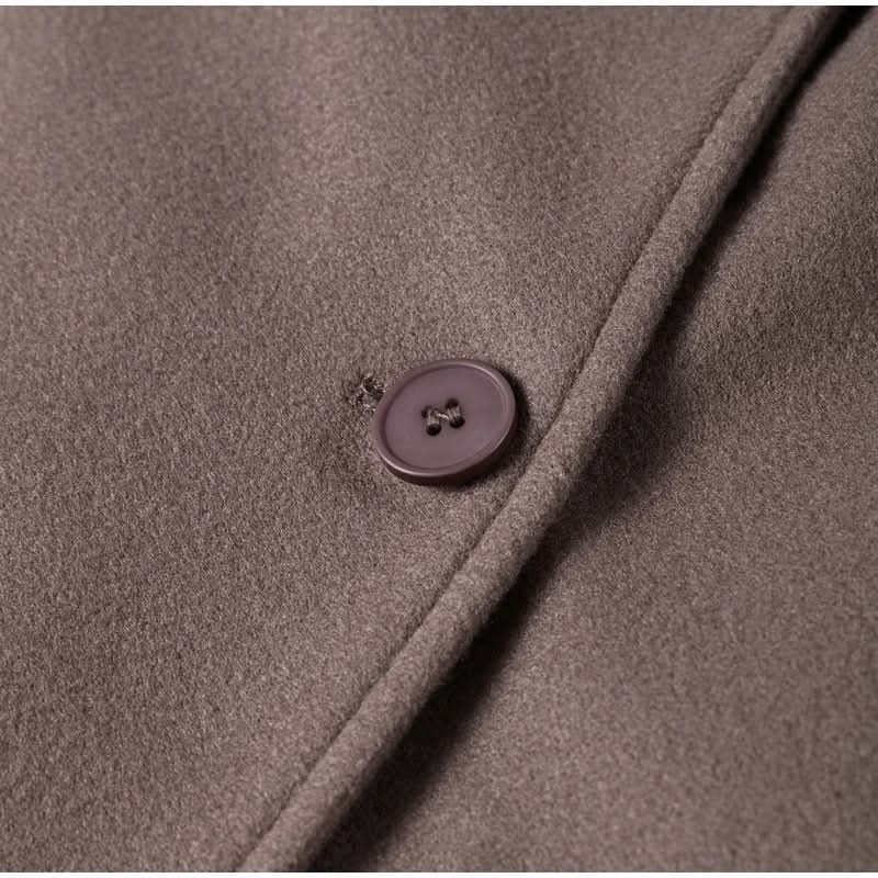 Close-up of taupe coat button and fabric texture detail