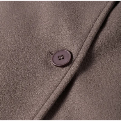 Close-up of taupe coat button and fabric texture detail