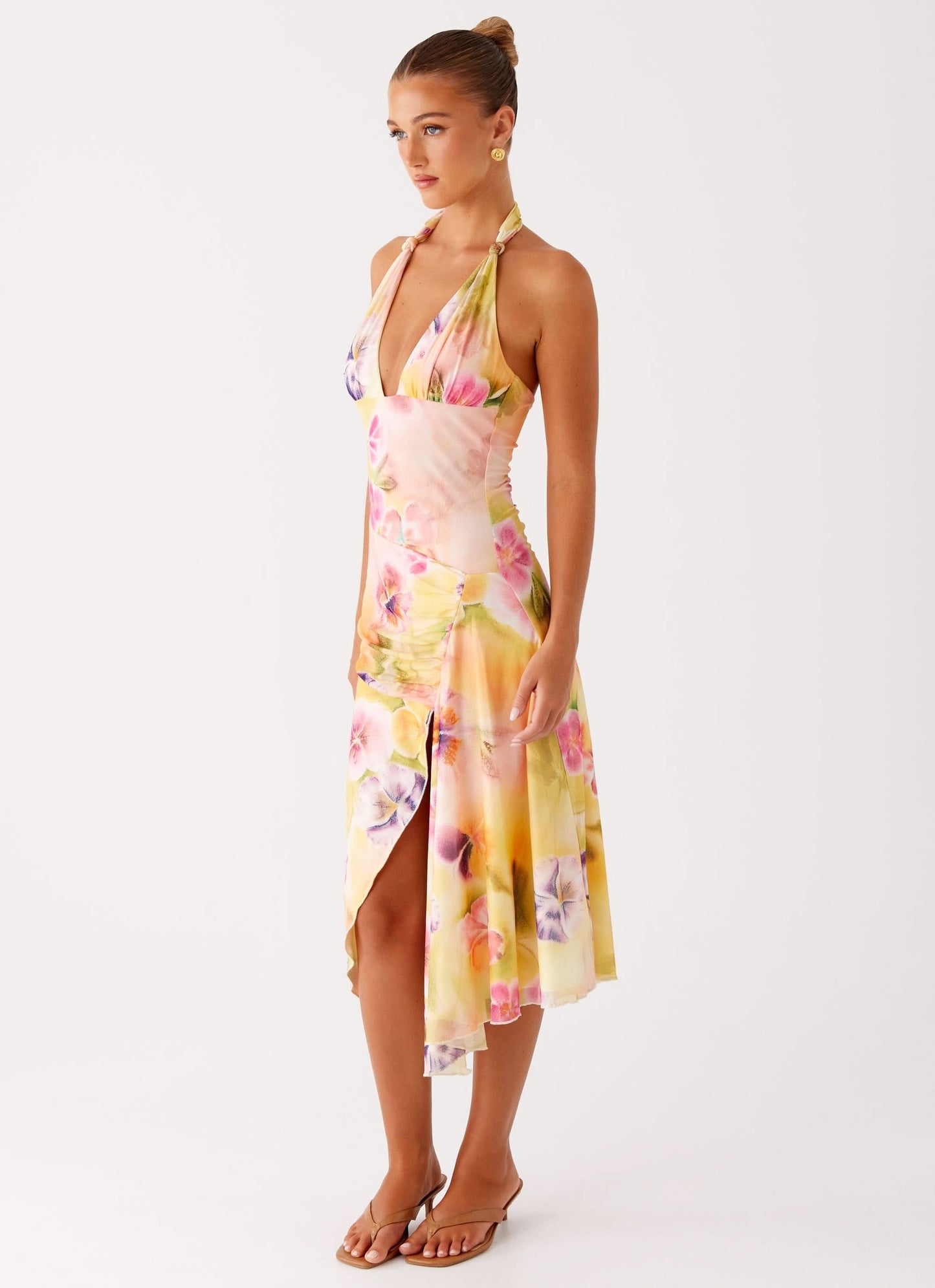 Side view of halter midi dress with asymmetrical hemline and watercolor florals
