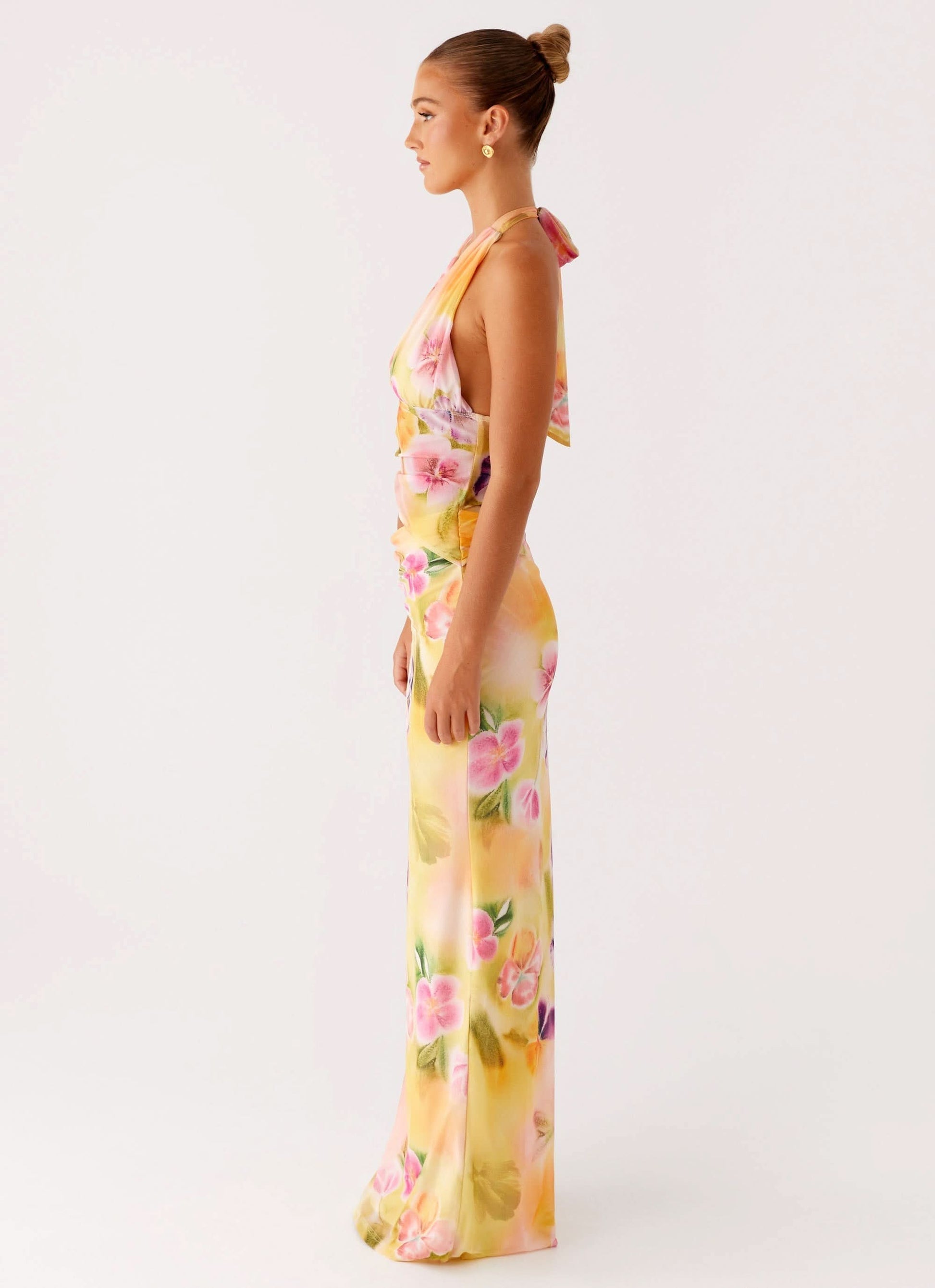 Side profile of halter midi dress with flowing skirt and floral print